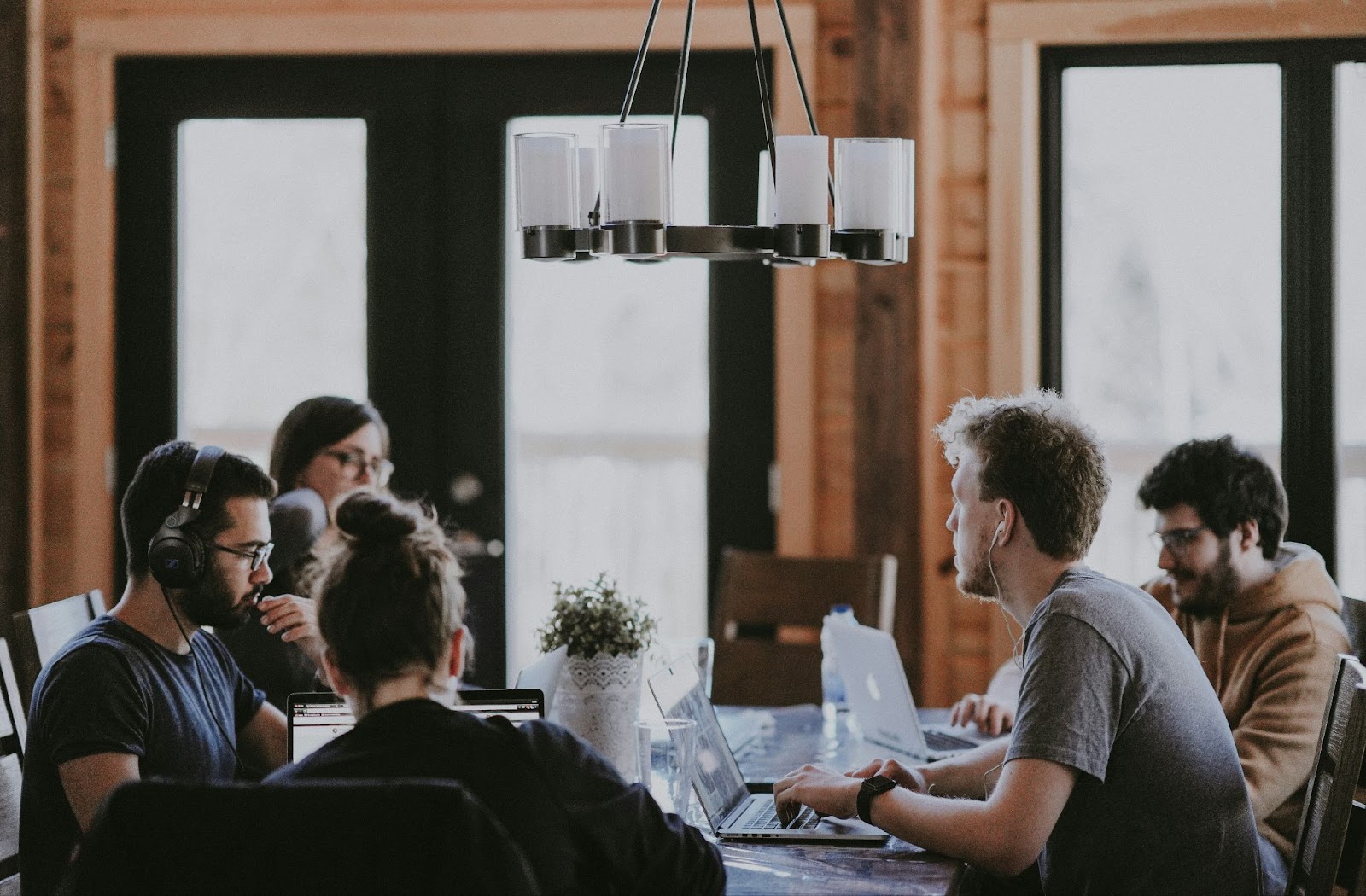 People talking around a table with computers 