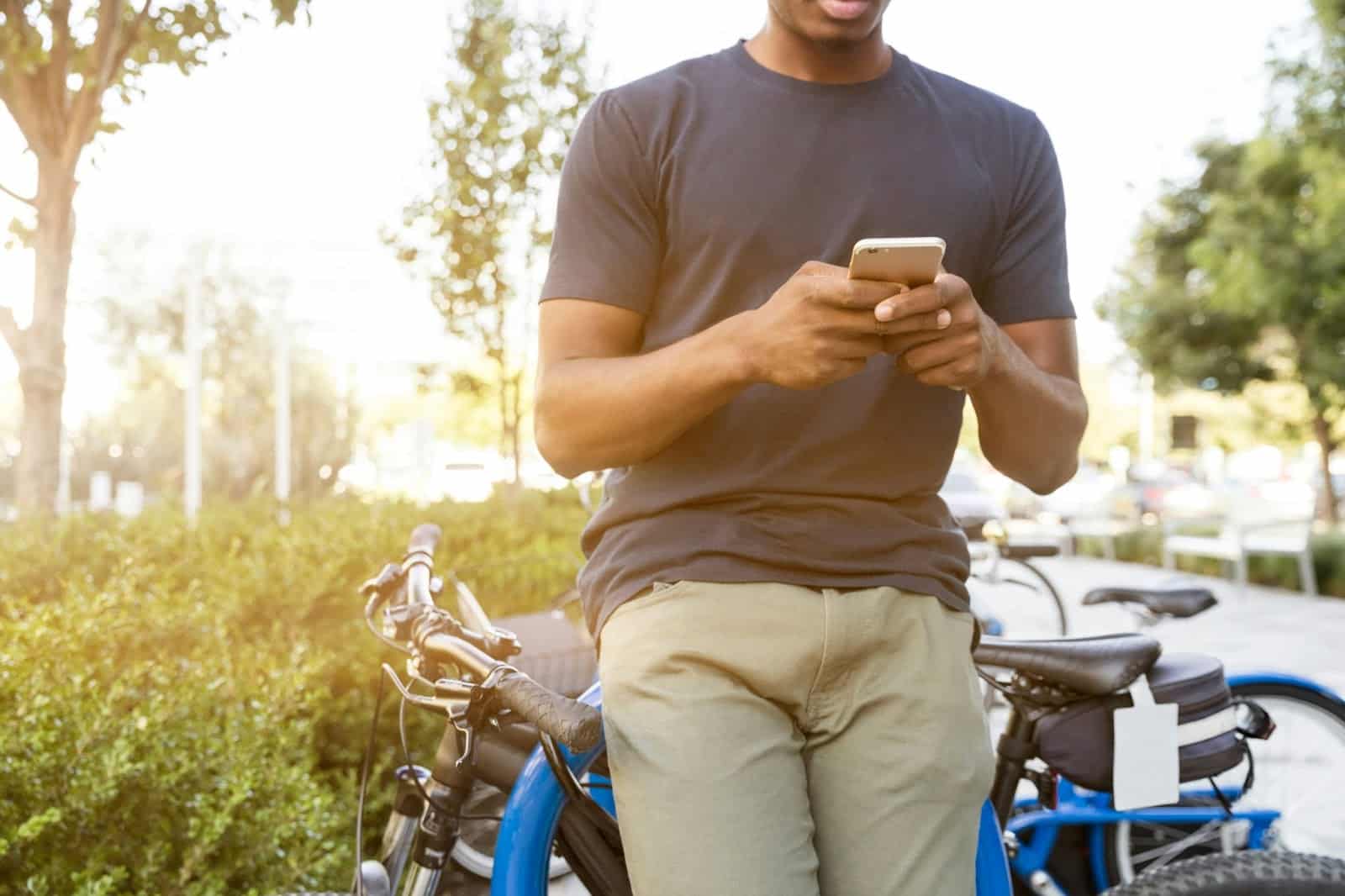 Person texting outside by their bike